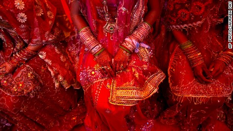 Indian brides from impoverished families, dressed in wedding finery, wait for their grooms to arrive during a mass marriage ceremony in New Delhi, India, Friday, Feb. 20, 2015. 