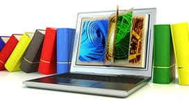 Photo of a stack of books and a computer in the middle with the abstract graphic on the screen