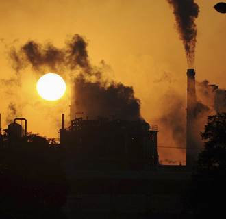 Image: Smoke billows from chimneys at a chemical factory in China.