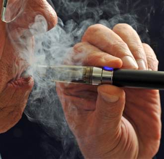 A smoker puffs on an e-cigarette. 