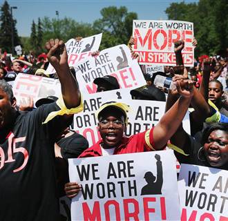 Image: Fast food workers and activists demonstrate outside the McDonald's corporate campus on May 21, for a higher wage