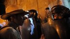 A demonstrator talks to a riot police officer during a protest in Bogota, Colombia, on 26 August, 2013