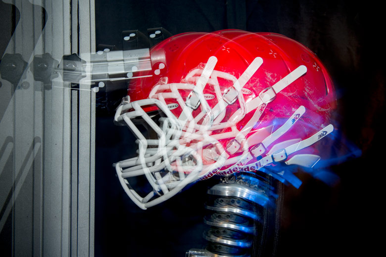Multi-exposure of a football helmet simulating impact on the top of the helmet. 
