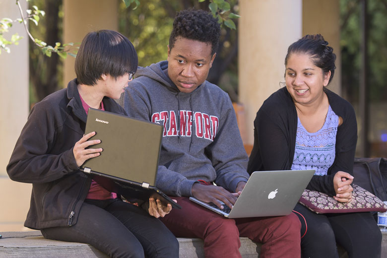 students Nikhita Obeegadoo, Eric Ehizokhale and Sophie Ye working on their laptops / L.A. Cicero