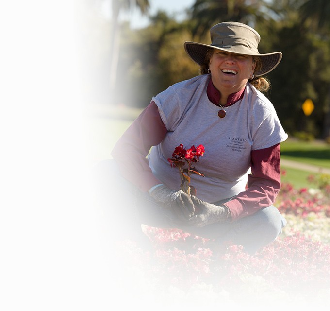 photo of Catherine Parrish wearing a hat and gardening