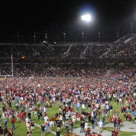 Stanford fans storm the field after the Cardinal's improbable 21-14 upset of USC on Saturday night. (SIMON WARBY/The Stanford Daily)