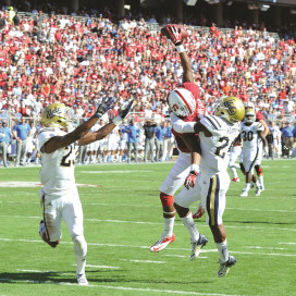 Sophomore wide receiver Kodi Whitfield (middle) made an eye-popping one-handed grab in traffic against UCLA Saturday, putting the Card up for good. (MIKE KHEIR/The Stanford Daily)