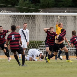 Fifth-year senior midfielder Austin Meyer (far left) and junior midfielder Ty Thompson (center) celebrate after Meyer scored the golden goal in double overtime to net the Cardinal not only a 3-2 victory in the Big Derby, but the team's first conference title since 2001. (DAVID BERNAL/isiphotos.com)