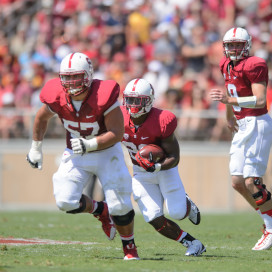 One of the keys to Stanford's game against UCLA will be whether the offensive line -- including senior right guard Johnny Caspers (left) -- can make holes for Stanford's running game. Stanford's several offensive threats on the ground -- including fifth-year senior Remound Wright (center) and sophomore Christian McCaffrey -- also have a chance to do well against a UCLA defense that has experienced several season-ending injury. (JOHN TODD/isiphotos.com)