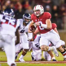 Fifth-year senior Kevin Hogan (center right) produced another sterling performance in Saturday night's win over Arizona, completing 89.5 percent of his passes and throwing 2 touchdowns in the Cardinal's 55-17 rout of Arizona. (SAM GIRVIN/ The Stanford Daily)