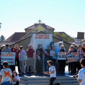 A group of local alumni joined in the sit-in on Thursday and marched to the Alumni Center to say that they will not donate if the University continues to invest in fossil fuels.(McKENZIE LYNCH/The Stanford Daily)