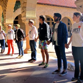 Students from Fossil Free Stanford surrounded Building 10 after being denied entry by the police officers (RAGHAV MEHROTRA/The Stanford Daily).