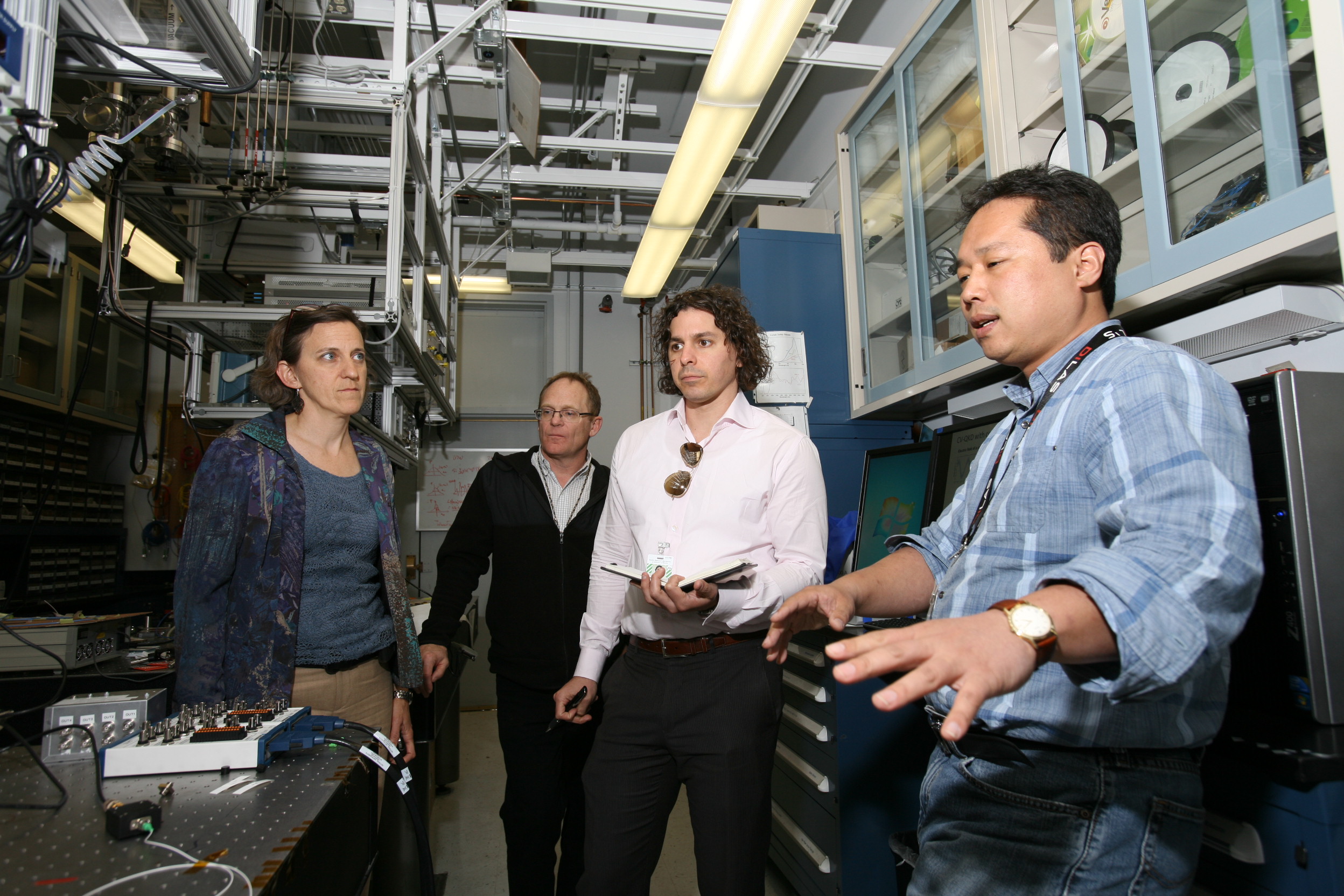 Team members talk in a server room