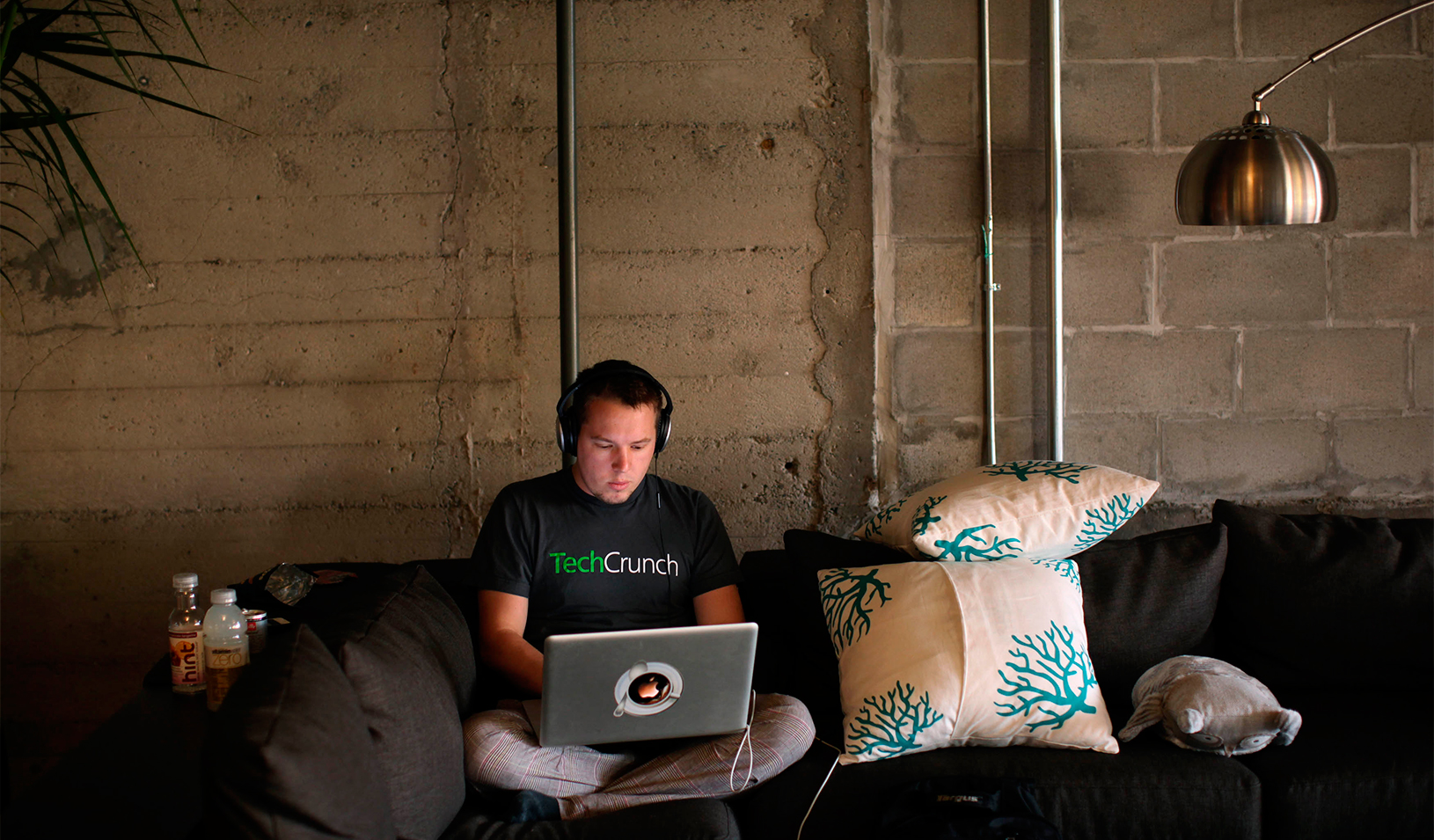 Engineer Buford Taylor sits on a couch as he works on his computer at Eventbrite headquarters in the South of Market area in San Francisco, California