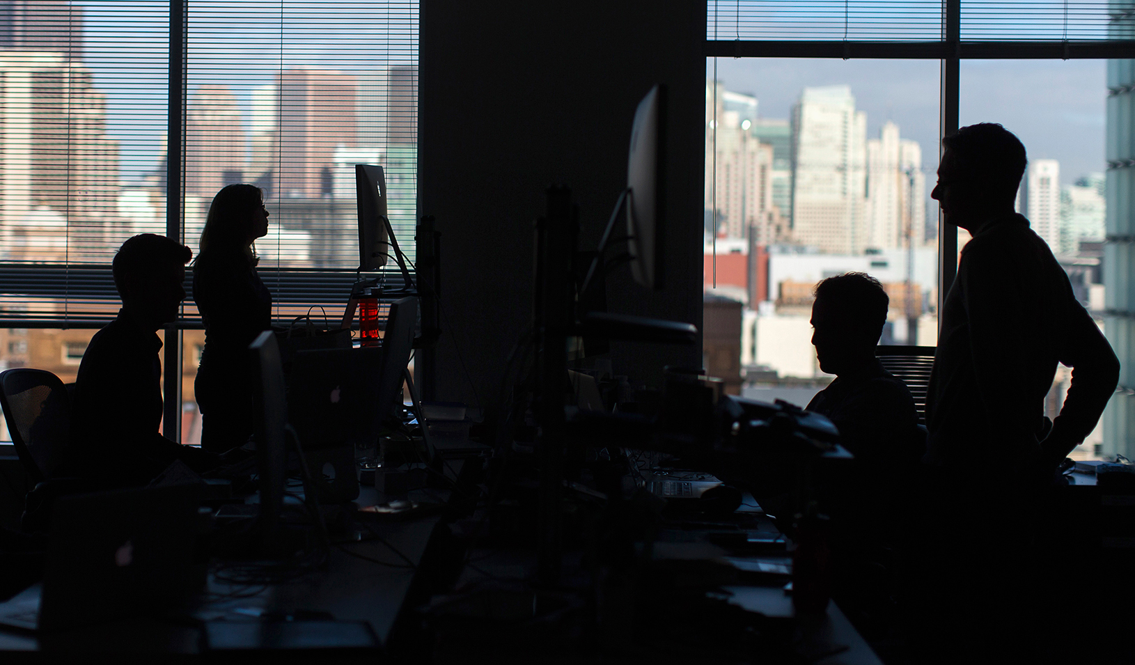 A group of office employees work in front of computers and their work | Reuters/Stephen Lam