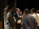 Associate Attorney General Tom Perrelli and Neil Irvin of Men Can Stop Rape talk with Benjamin Banneker students following the question and answer session.