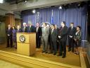 AG Eric Holder stands with HUD Secretary Shaun Donovan, Iowa AG Miller and other attending attorneys