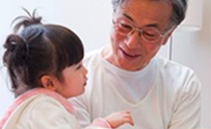 photo of man smiling at small child