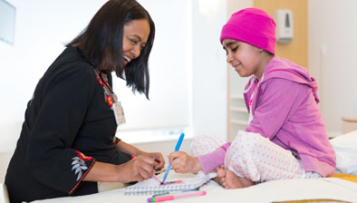 Young patient at the Bass Center, coloring with Dr. Rajni Agarwal 
