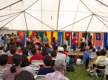 Students on stage dancing at a festival