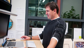 Male staff working at office computer