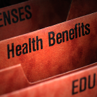 Red file folders labelled "Health Benefits"