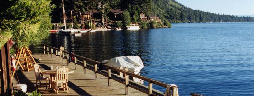 Chairs on dock along Fallen Leaf Lake, mountains and lodge in near distance
