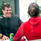 Male staffer talking to female staffer across desk