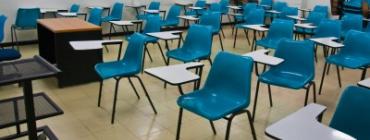 classroom full of empty blue desks