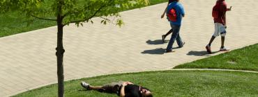 students walking to class in a grassy area