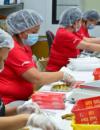 workers assembling materials in factory assembly line