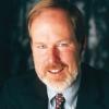 man with blond hair and facial hair in a suit