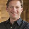 man with short brown hair in black collared shirt