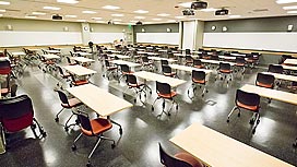 Photo of a large empty classroom with table and chairs