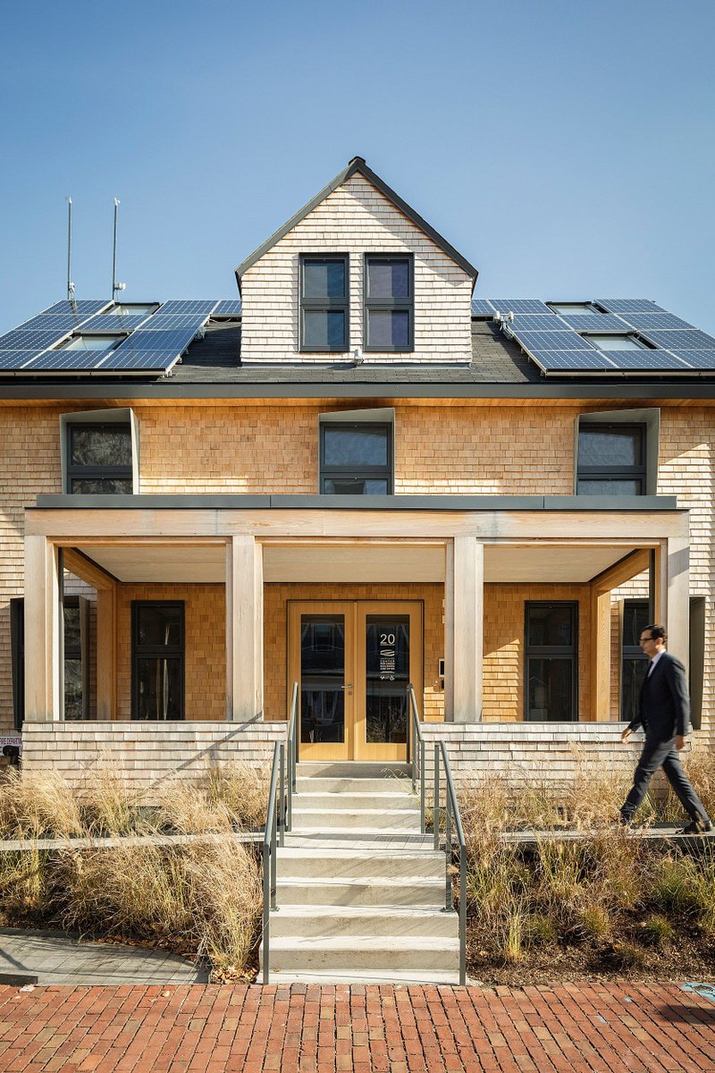 The exterior of HouseZero with a man walking in front