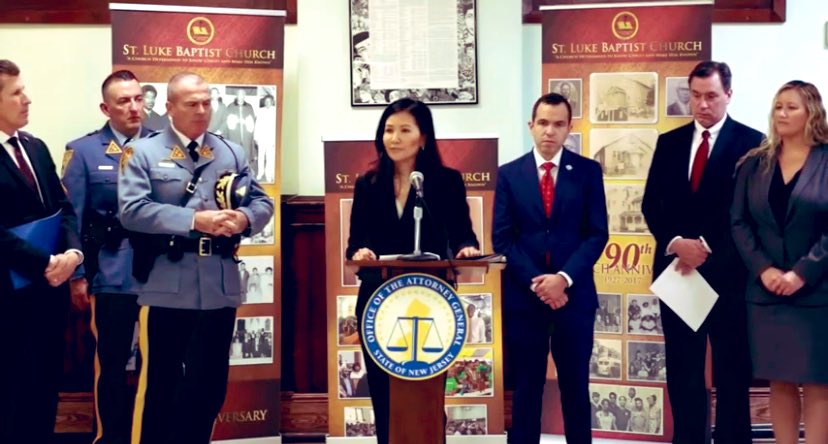 NJ Division of Criminal Justice Chief Pearl Minato at a podium during press conference. Other law enforcement officials to her left and right. 

15 Alleged Members of a Paterson Gun Trafficking Ring Charged with Transporting Guns from South Carolina for Illegal Sale in NJ. Proud to have protected the public with great partners @NewJerseyOAG @NJSP NJ DCJ. #NoBetterPartner