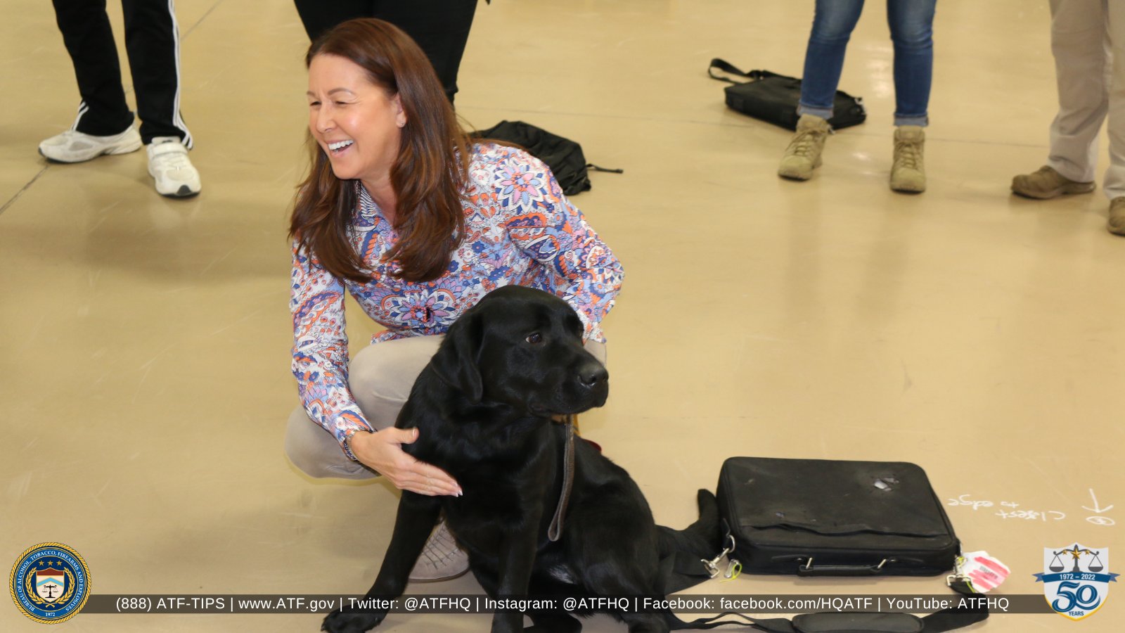 ATF employee with a K-9 who has recently started her accelerant detection training at the ATF Canine Training Center.