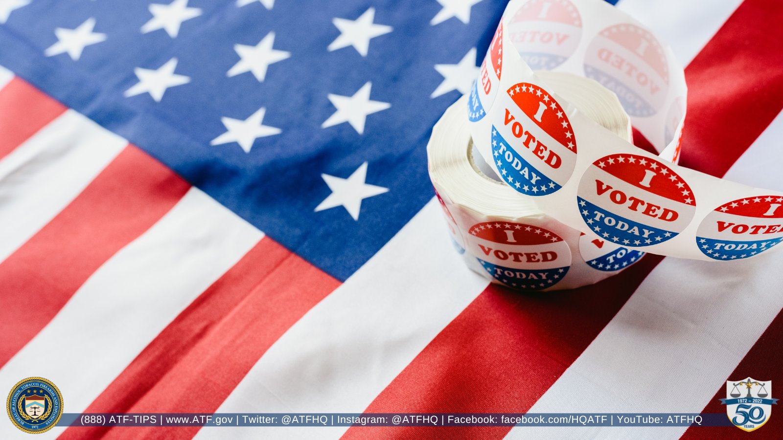 A roll of "I voted today" stickers resting on a U.S. flag