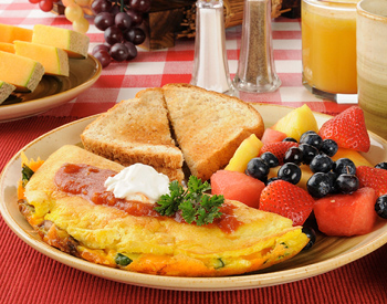 A breakfast plate with toast, fruit and eggs. 