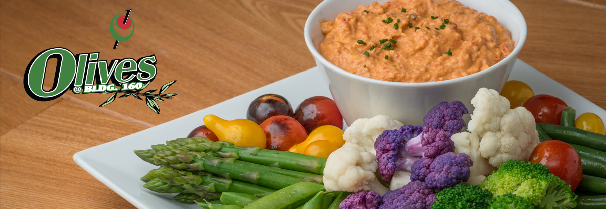 Olives catering platter with fresh vegetables and hummus