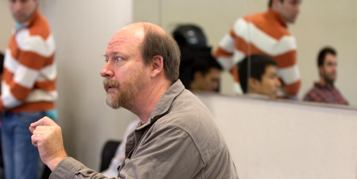 Dr. Tom Freeland teaching, students listening