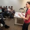 Grad student speaking in front of a group of students seated in a classroom