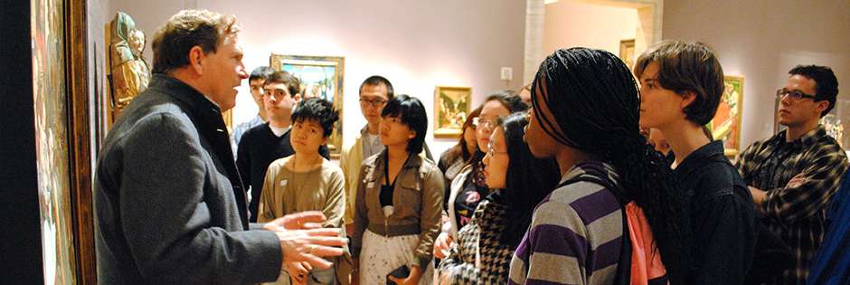 A SLE instructor with students at a museum.