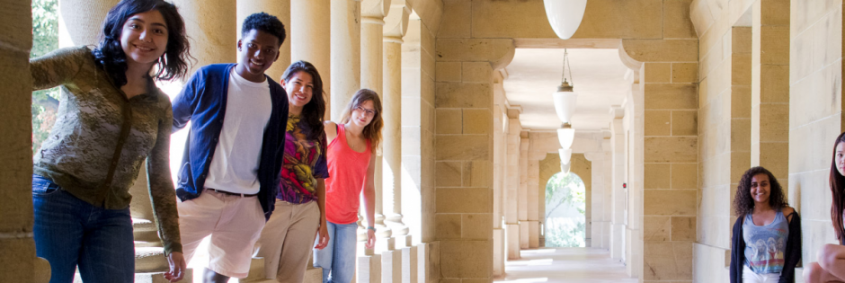 LSP students standing between columns in the Main Quad