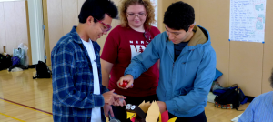 Three students work together on a project