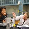Jennifer Schwartz Poehlmann works with a Stanford student participating in the Leland Scholars Program, in a chemistry lab.
