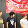 Three 2012 Leland Scholars Program students in their dorm at Stanford University, standing under an LSP banner.