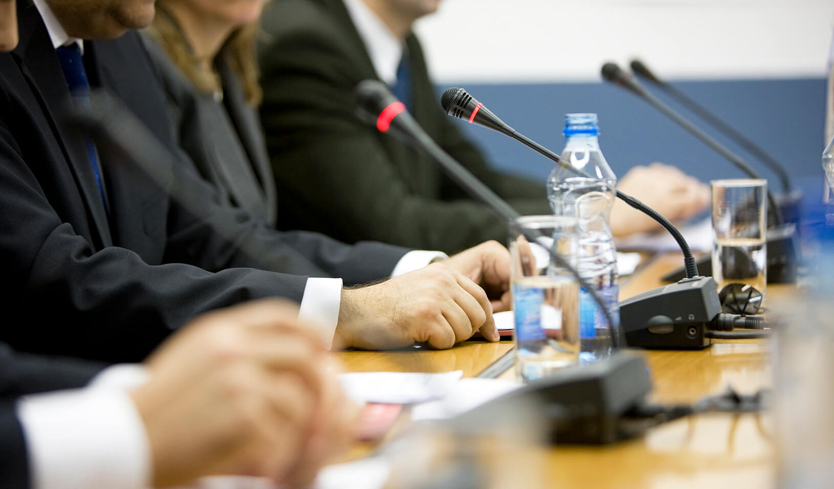  Close up of a panel of speakers | iStock/webphotographeer