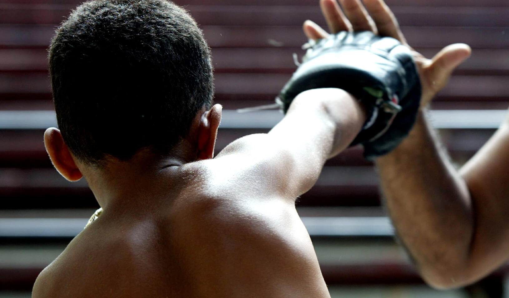 A picture of a young boy learning to box | Reuters/Claudia Daut