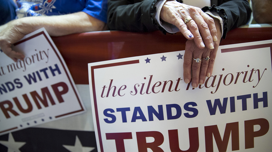 Trump supporters with campaign signs